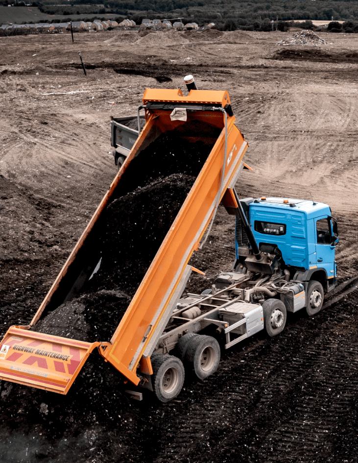 Mechanic carrying out regular maintenance and servicing on a large fleet of trucks.